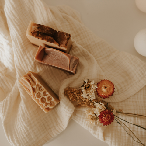 An assortment of 3 fall soaps with dried flowers.